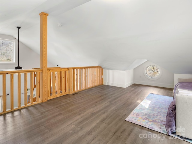 bonus room with dark hardwood / wood-style flooring and lofted ceiling