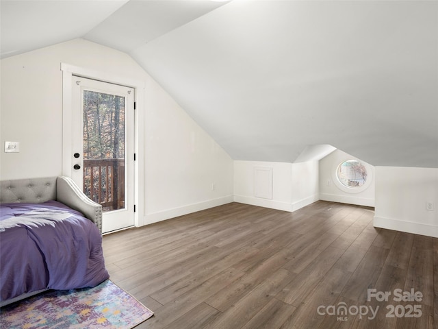 bedroom with vaulted ceiling, access to outside, and dark hardwood / wood-style flooring