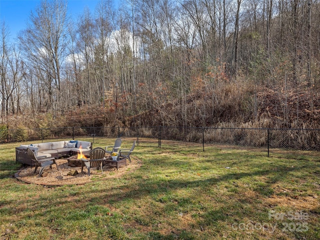 view of yard featuring an outdoor living space with a fire pit