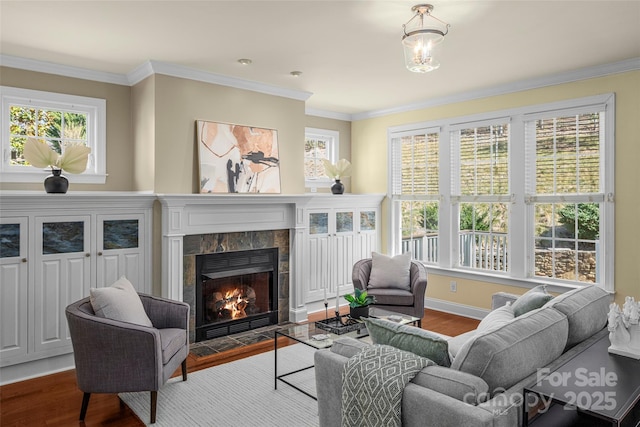 living area featuring plenty of natural light, wood finished floors, and a tiled fireplace