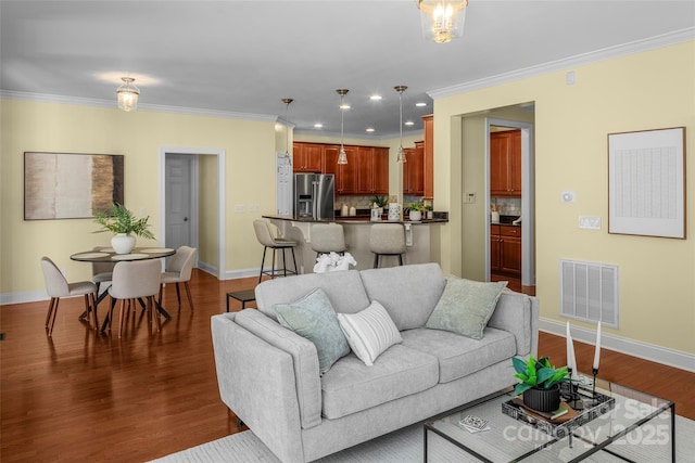 living area featuring crown molding, baseboards, visible vents, and dark wood-style flooring