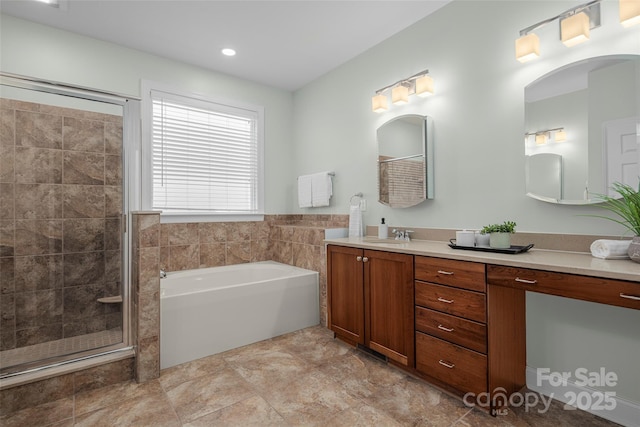 full bath featuring vanity, a garden tub, and a shower stall