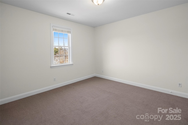 carpeted empty room with visible vents and baseboards