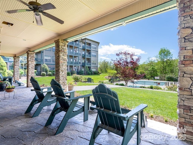 view of patio with ceiling fan and fence