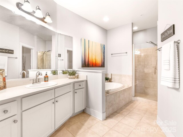 full bathroom featuring a shower stall, vanity, a bath, and tile patterned floors