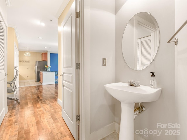 bathroom featuring recessed lighting, baseboards, and hardwood / wood-style flooring