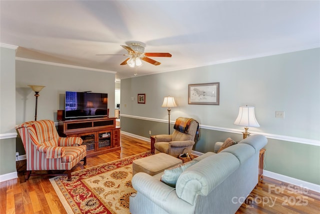 living room with ornamental molding, ceiling fan, and wood-type flooring