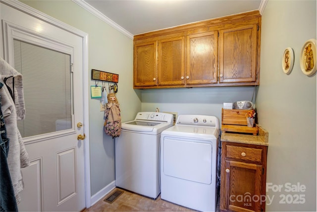 clothes washing area with ornamental molding, cabinets, and separate washer and dryer