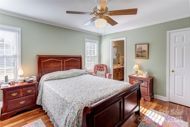 bedroom with multiple windows, crown molding, and light hardwood / wood-style floors