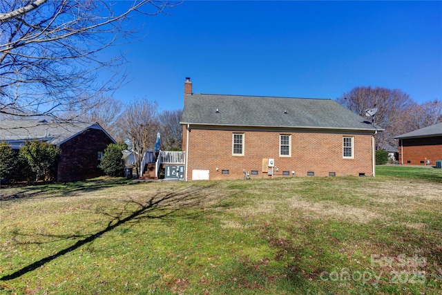 rear view of house featuring a yard