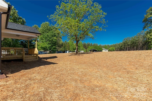 view of yard with a wooden deck