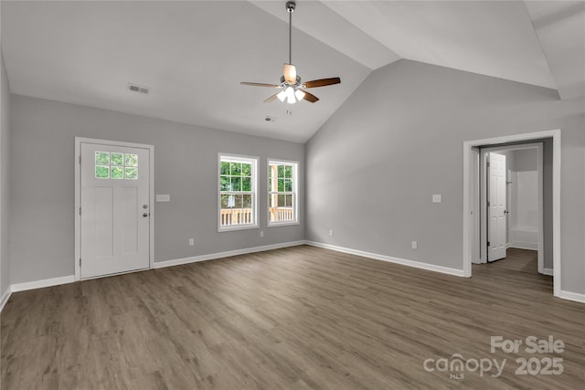 unfurnished living room featuring lofted ceiling, dark hardwood / wood-style floors, and ceiling fan