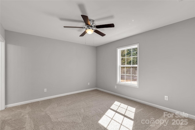 carpeted spare room with ceiling fan