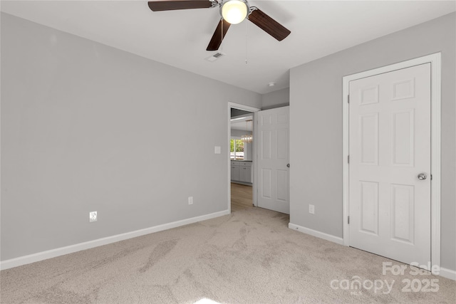 unfurnished bedroom with light carpet and ceiling fan