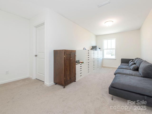 living room featuring light carpet, visible vents, and baseboards