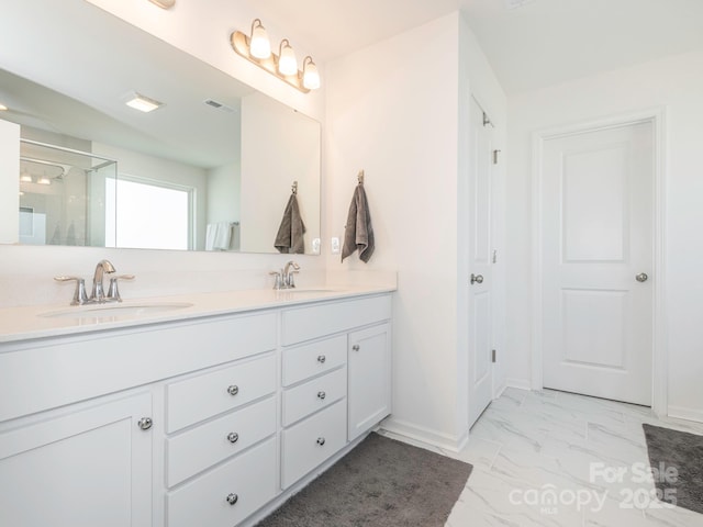 full bath featuring double vanity, marble finish floor, visible vents, and a sink