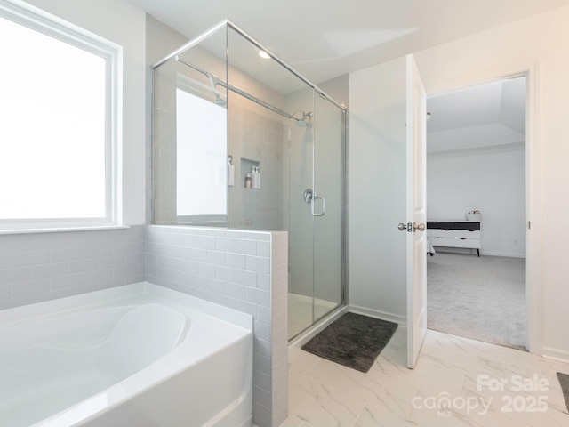 full bathroom with a stall shower, marble finish floor, and a garden tub