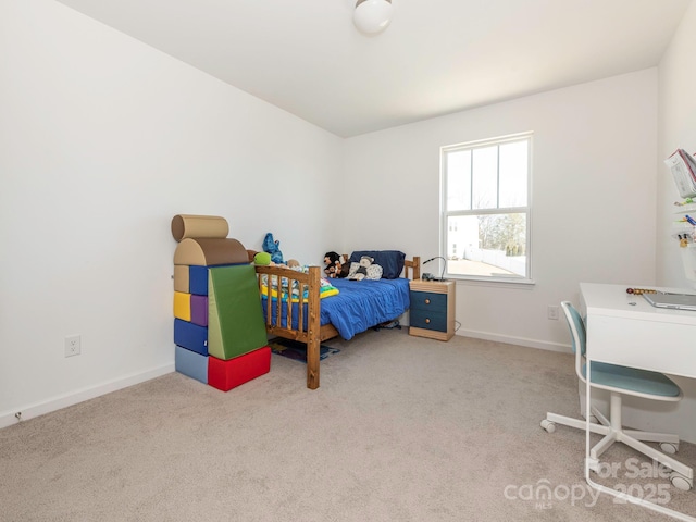 bedroom with light carpet and baseboards