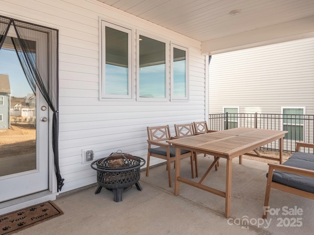 view of patio with a fire pit and outdoor dining space