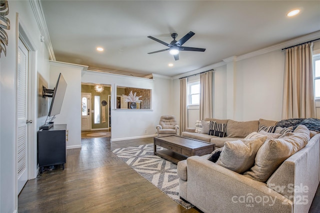 living room featuring dark wood-type flooring, ornamental molding, and ceiling fan