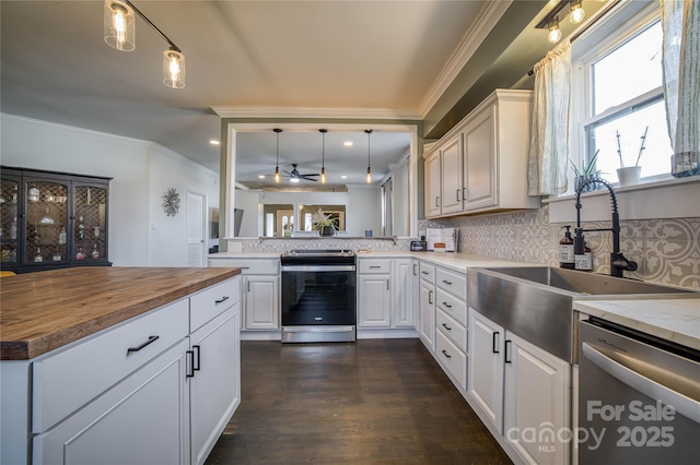 kitchen featuring pendant lighting, sink, white cabinetry, and appliances with stainless steel finishes