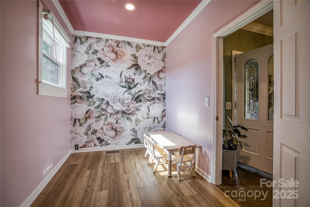 entryway with hardwood / wood-style floors and crown molding