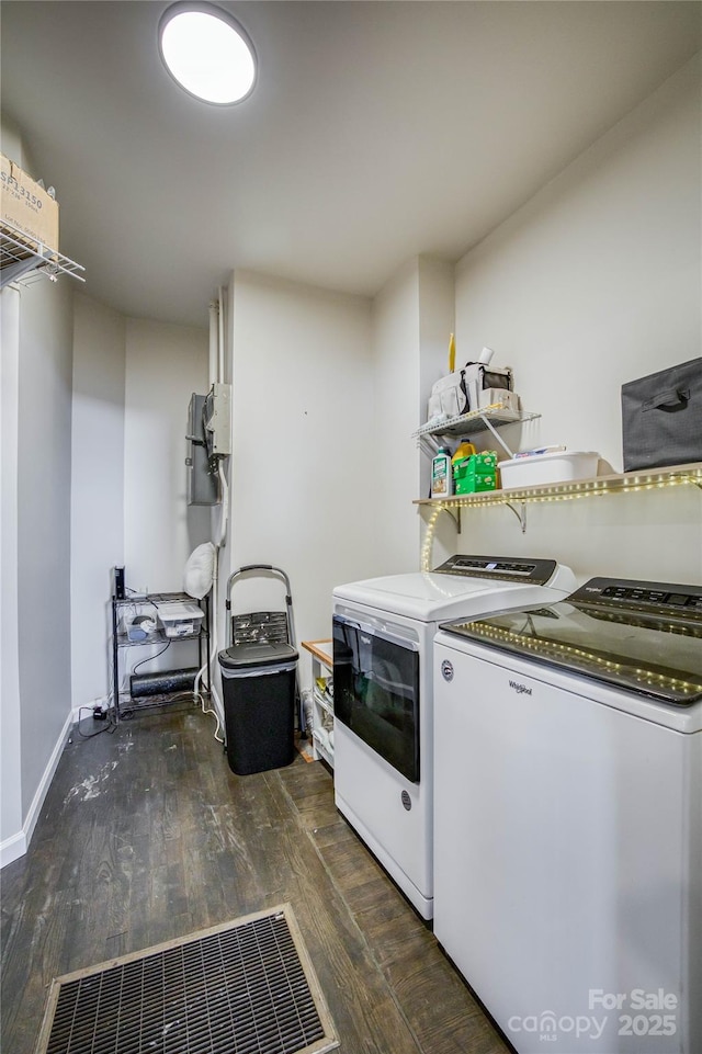 laundry area featuring dark wood-type flooring and washer and dryer