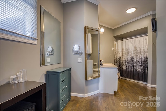 bathroom featuring wood-type flooring, vanity, and crown molding