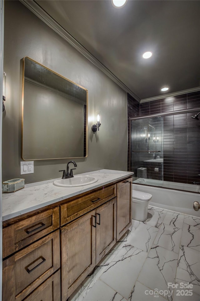 full bathroom featuring crown molding, vanity, bath / shower combo with glass door, and toilet