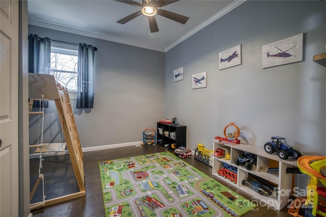 game room featuring ornamental molding, ceiling fan, and dark hardwood / wood-style flooring