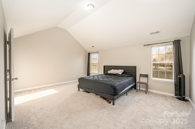 bedroom with carpet flooring, baseboards, visible vents, and vaulted ceiling