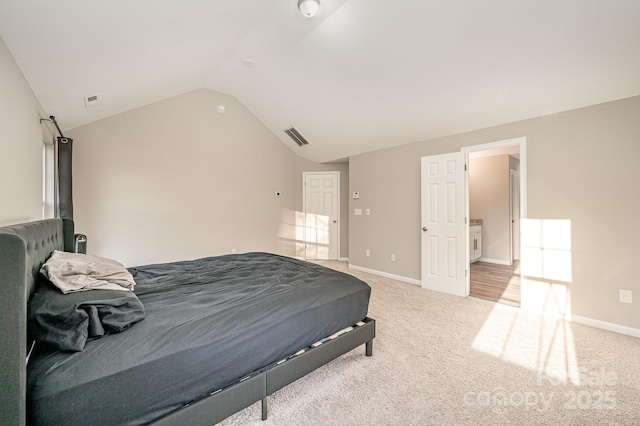 bedroom with lofted ceiling, visible vents, light carpet, and baseboards