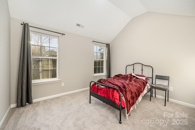 bedroom featuring light colored carpet, visible vents, lofted ceiling, and multiple windows