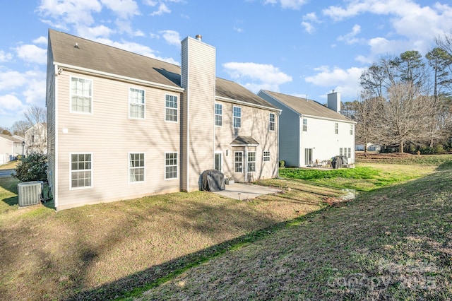 rear view of property featuring a patio, a lawn, and central AC unit