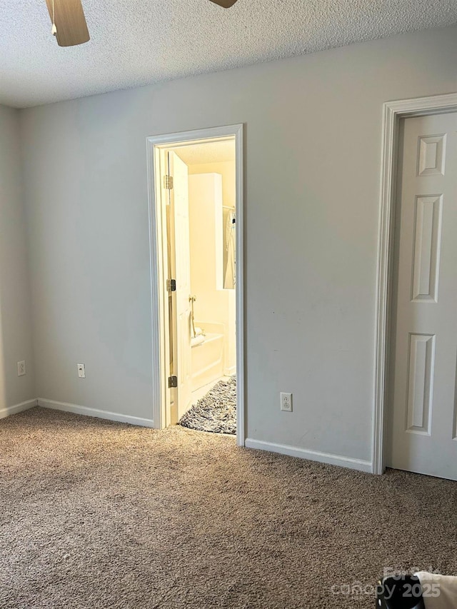 spare room with ceiling fan, a textured ceiling, carpet, and baseboards