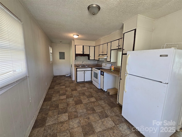 kitchen with white appliances, sink, and a textured ceiling