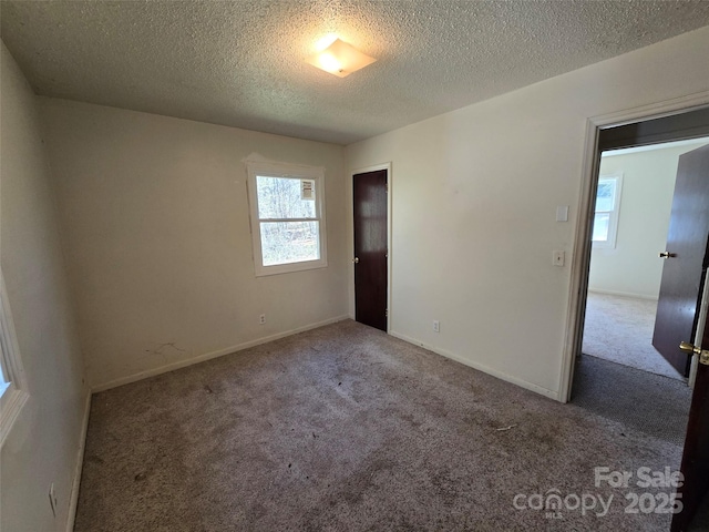 unfurnished bedroom featuring light colored carpet and a textured ceiling