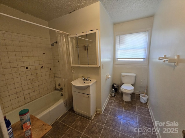 full bathroom featuring shower / bath combination with curtain, vanity, tile patterned floors, and a textured ceiling