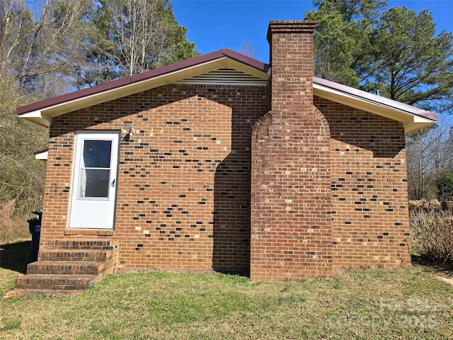 view of side of home featuring a yard