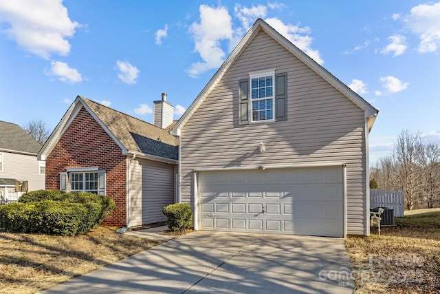 traditional-style home featuring brick siding, central air condition unit, a shingled roof, a garage, and driveway