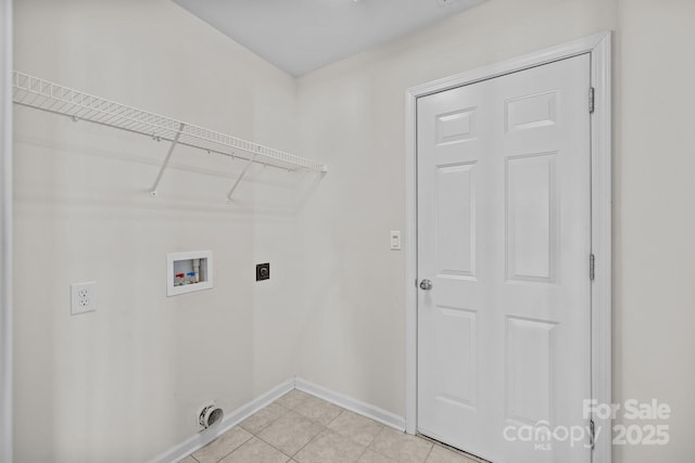 washroom with light tile patterned floors, hookup for an electric dryer, laundry area, washer hookup, and baseboards