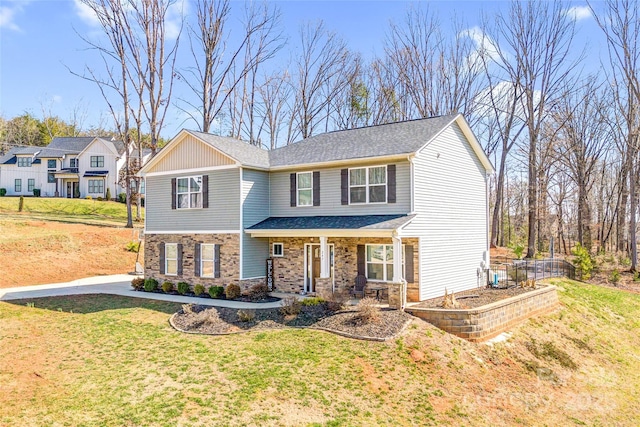 view of front of house featuring stone siding, a front lawn, and a porch