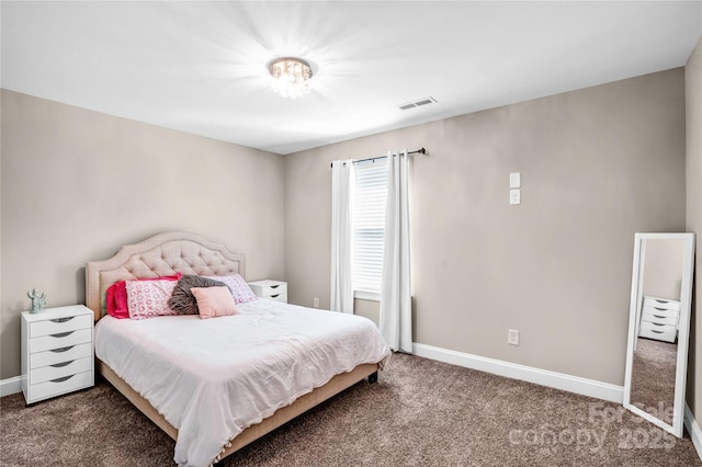 carpeted bedroom featuring baseboards and visible vents