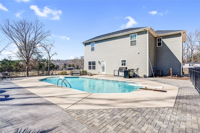 view of swimming pool featuring a fenced in pool, a patio, grilling area, fence, and a diving board