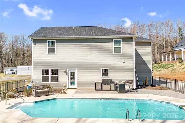 back of property featuring a fenced in pool, a patio area, and a fenced backyard