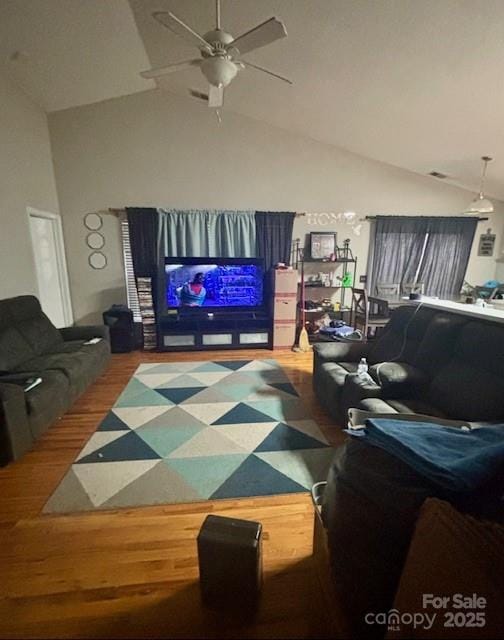 living area featuring high vaulted ceiling, wood finished floors, and a ceiling fan