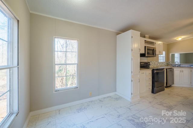 kitchen with white cabinets, appliances with stainless steel finishes, a textured ceiling, and ornamental molding