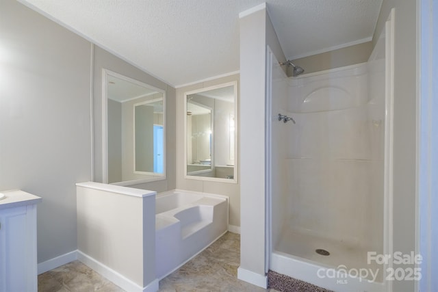 bathroom featuring a textured ceiling, separate shower and tub, and vanity