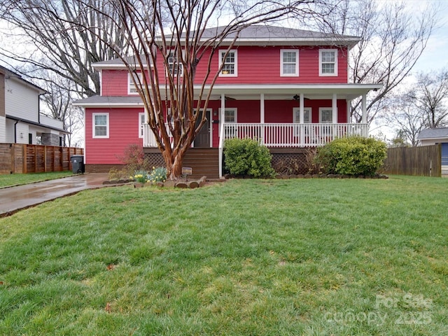 view of front of property with a front lawn, fence, and a porch