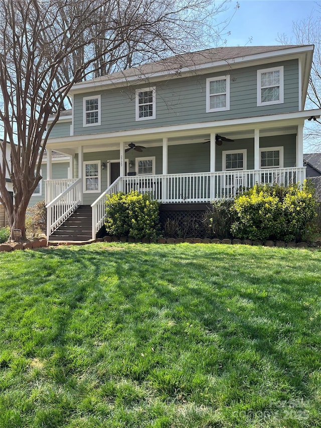 view of front facade with a front lawn, a ceiling fan, and covered porch